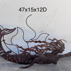 heavy metal mermaid  wall hanging has 2 pillar candle holders+located in Hedionda Pt