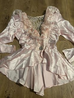 1980s-style pink satin and lace blouse or a peplum lingerie top, often characterized by its ornate ruffles, sheer lace panels, and cinched waist. Size