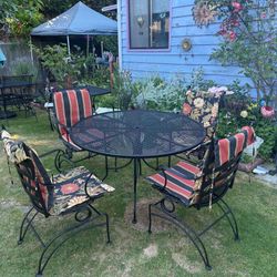 Wrought iron Table And four matching chairs
