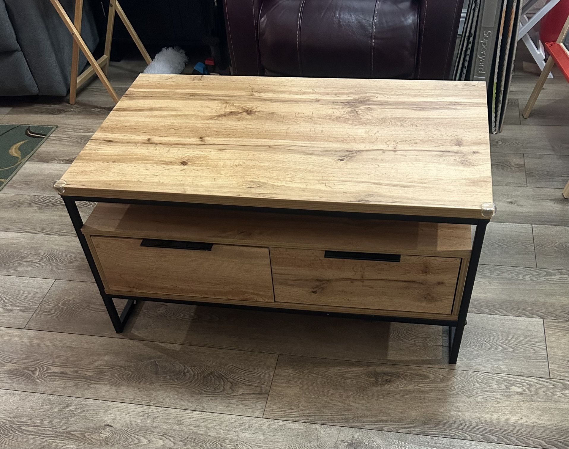 Wooden coffee table with metal frame and two storage drawers with additional storage. In good condition Dimensions are 40 inches by 24 inches with a
