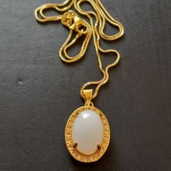 GOLD PLATED WHITE JADE PENDANT WITH CHAIN. 17" CHAIN.
