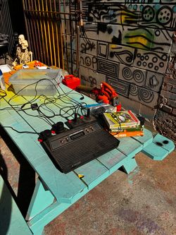 Atari console with three games, two joy sticks, two paddles and cords (untested)