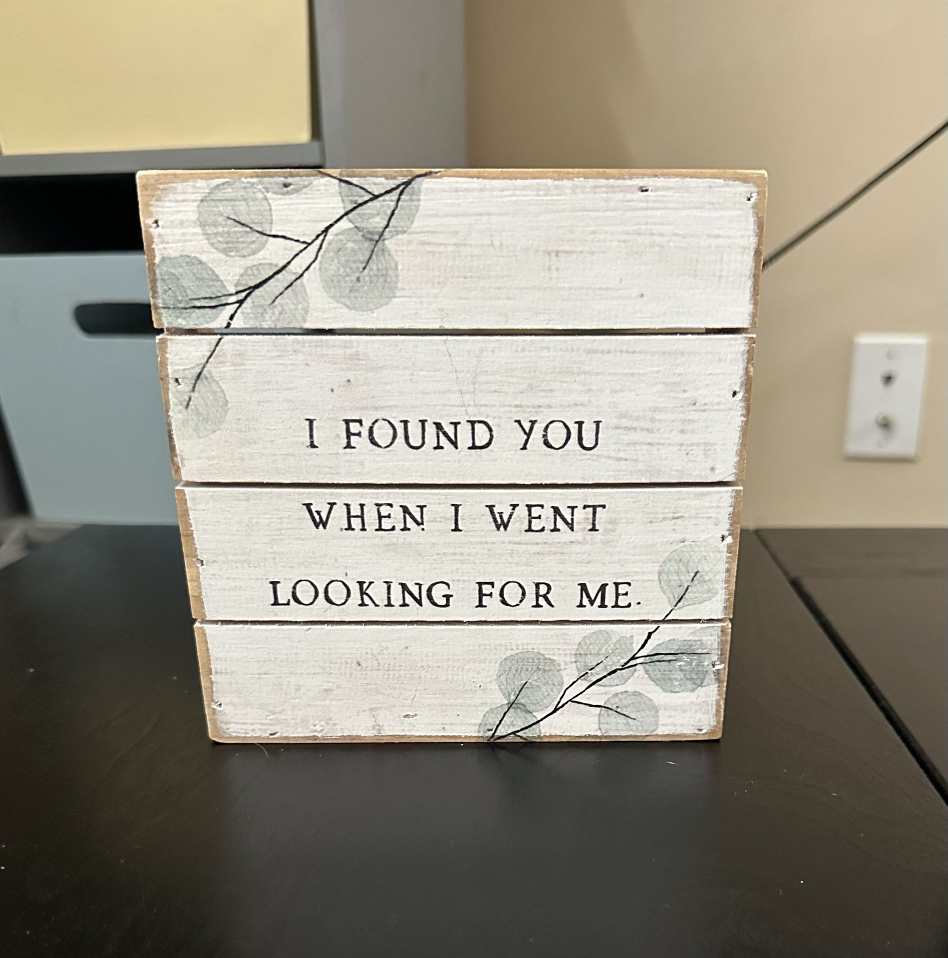 Rustic sign reads "I Found You When I Went Looking For Me”
