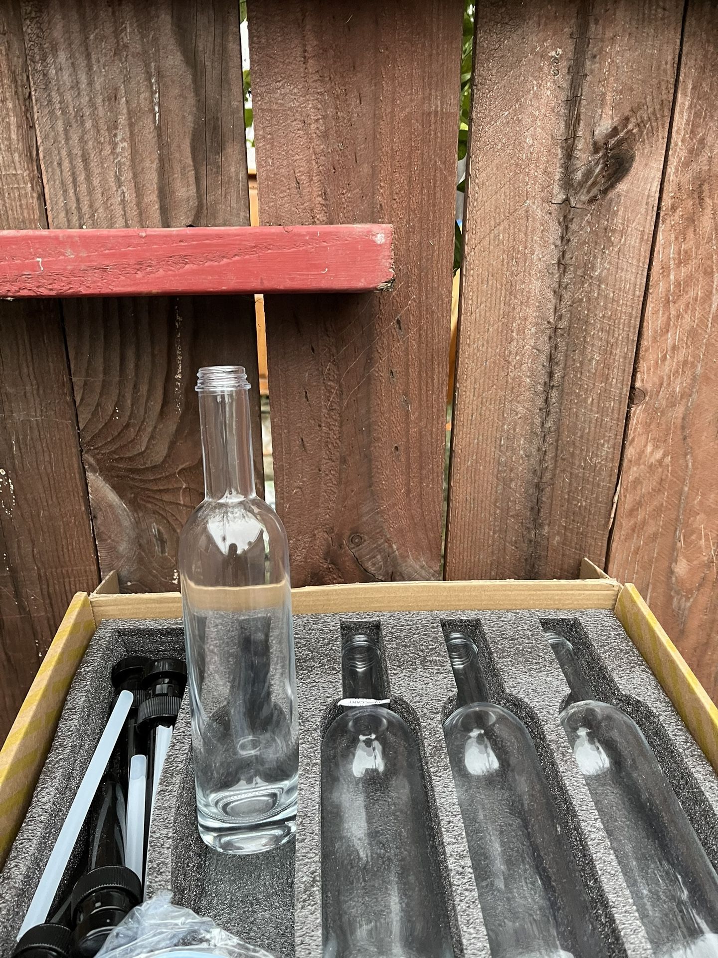 four 750 ml clear glass bottles. 