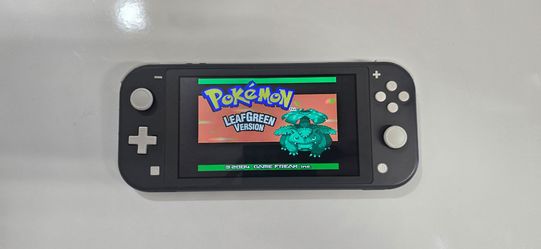 Nintendo Switch lite in gray with Pokémon FireRed and Pokemon LeafGreen