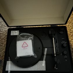 turntable record player with built-in speakers and Bluetooth.