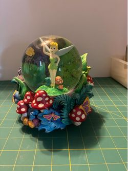 A musical Disney Tinker Bell garden snow globe featuring the tune “You Can Fly.”