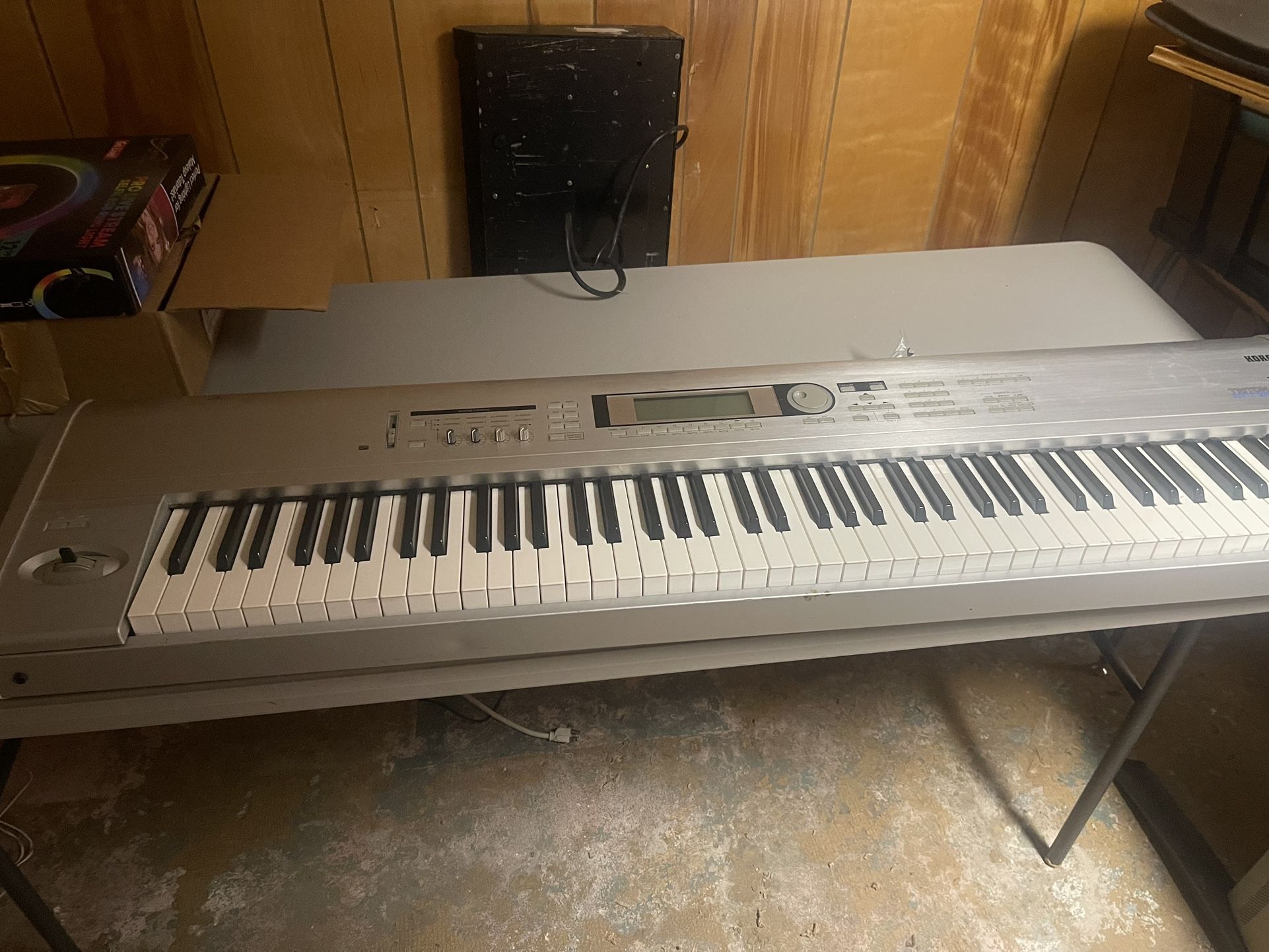 Korg Triton Weighted LE 88-Key synth with power chord.