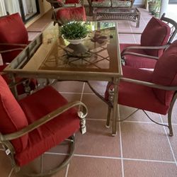 Patio dining table with red cushions  