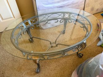 Elegant glass top coffee table with metal frame.