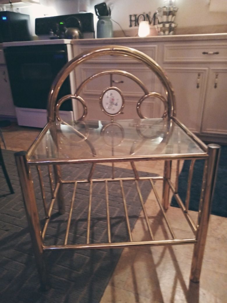 antique brass stand with glass top and undercarriage