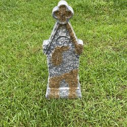 Tombstone With Fake Vines Growing Up It