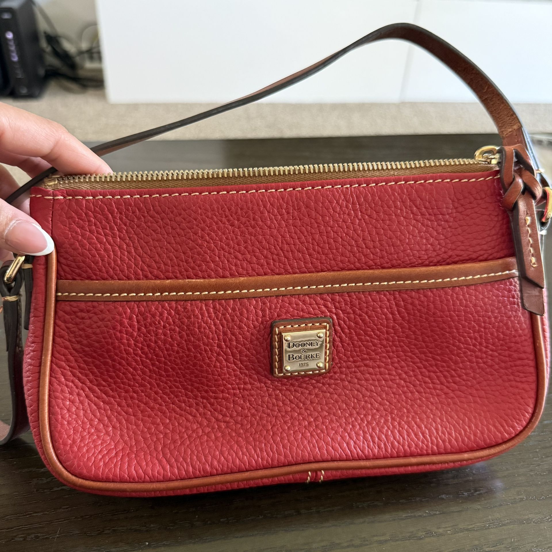Dooney & Bourke Pebble Grain Ginger Crossbody bag in red.