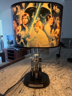 Star Wars themed lamp with iconic characters and lightsaber design.