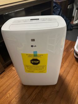 Portable air conditioner and window venting kit