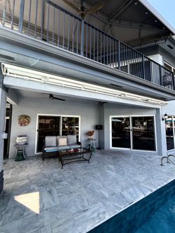 22’x7’ SOLIDUX RETRACTABLE MOTORIZED AWNING, tan canvas, white frame. Exc