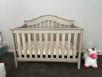 Wooden baby crib with mattress