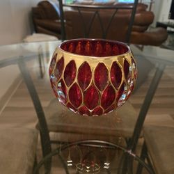 Red crystal vase which can also be used as candle holder; NOTE: If it's posted; it's available.  