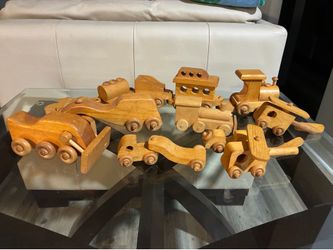 Vintage hand-carved wooden toy vehicle set from 1985.