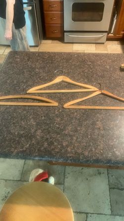 3 antique wood hanger from to hotels and one dryer cleaners