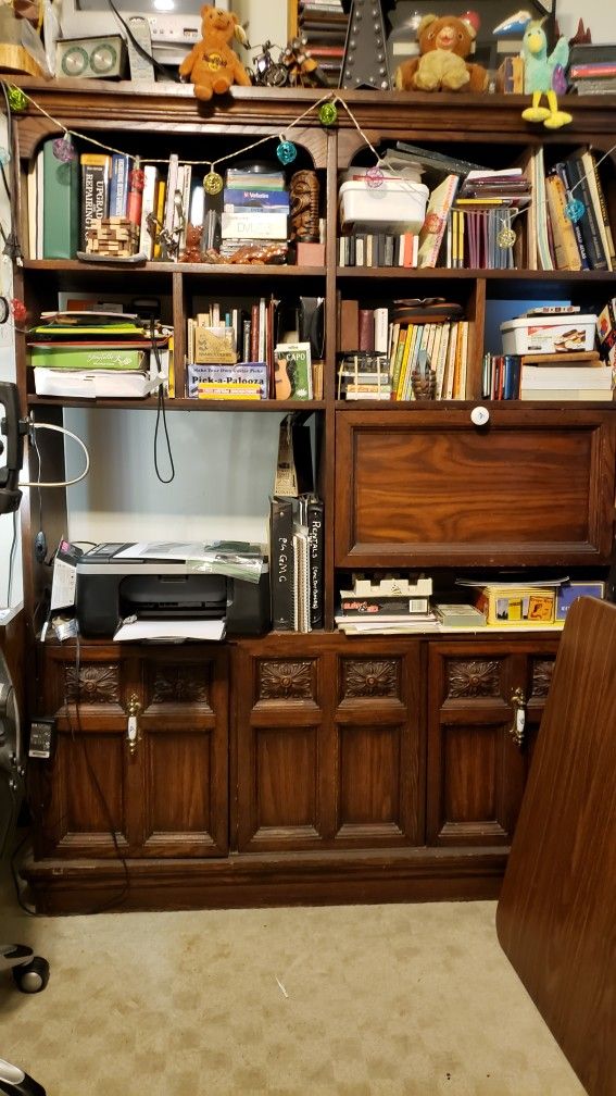 Antique book shelf with 6 cubby holes, one thin storage area,one  large area   and  bottom  storage area doors and  drop down desk)