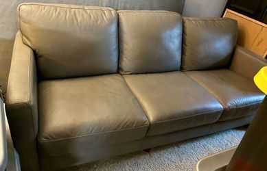 Price tag still on Macy’s Gray  leather couch in great condition!