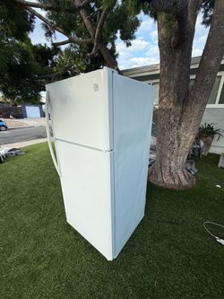 White, two-door refrigerator—65 inches—in very good condition and very clean.