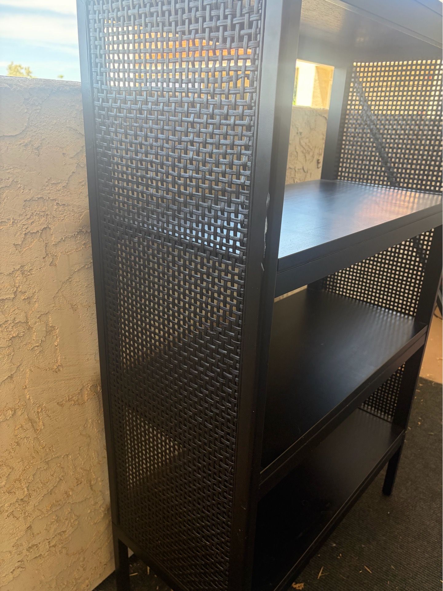 Black shelf with wicker sides