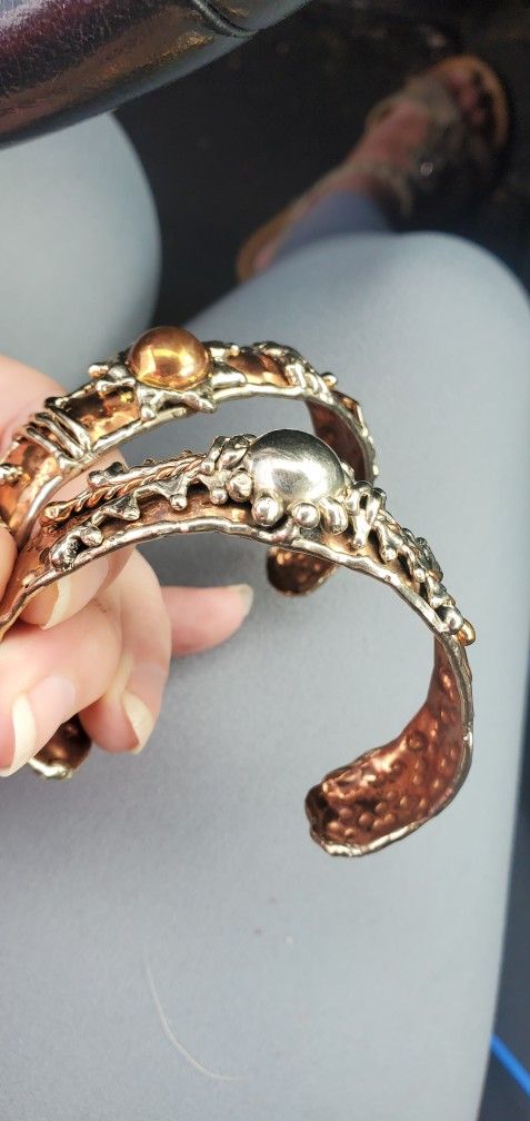 Silver And Copper Bracelets.