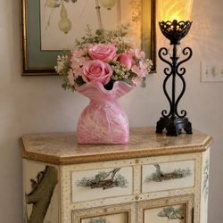 Beautiful pink hand blown art glass vase with elegant ruffled top and decorative bow detail, measures approximately 6.5 inches tall and 5 inches wide,