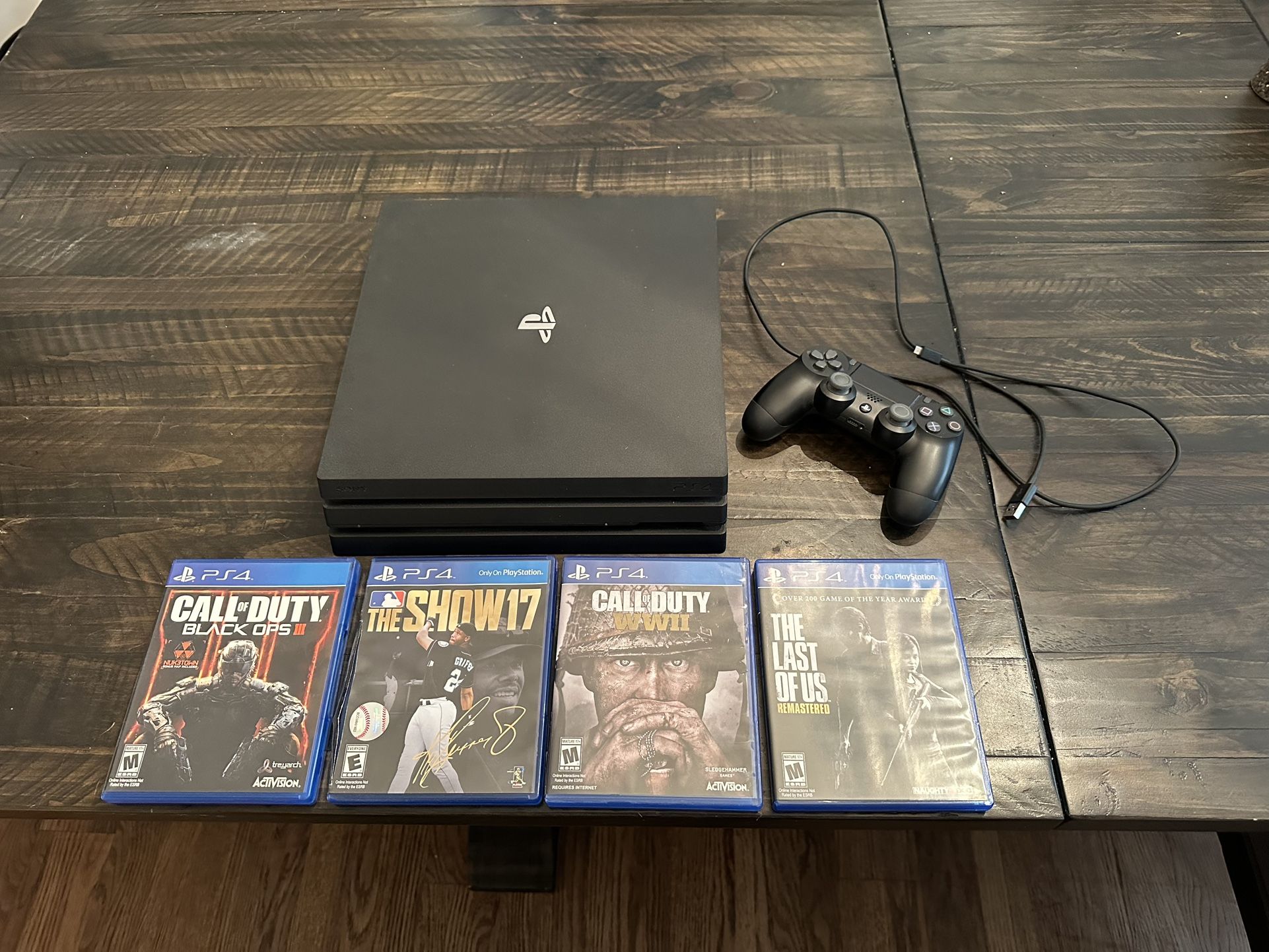 PS4 Pro 1TB with controller and 4 games.