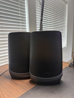 2 NETGEAR Orbi RBSE960B WiFi 6E mesh satellites.