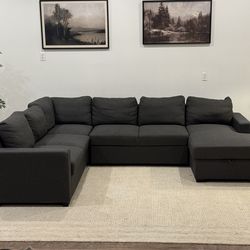 Dark gray sectional sofa with pullout sleeper delivery available