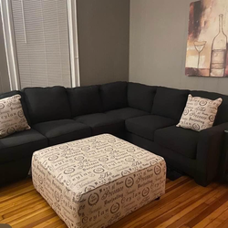 Sectional couch with pillows and ottoman