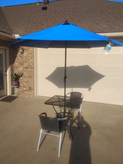 Patio table two chairs and a canopy top