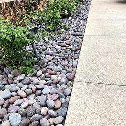 Landscaping beach pebbles and black polish pebbles