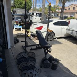 Bench press/squat rack with 7ft 45lbs bar and 256lbs of weights plus dumbbells handles with weights