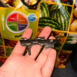 Small black futuristic gun figurine with useable handle