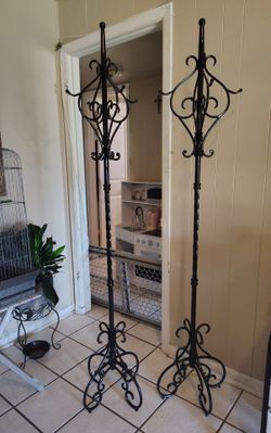 Used Metal coat rack stand featuring ornate scrollwork and multiple hanging hooks.