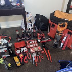 Milwaukee pack out game box full of Milwaukee tools, power and hand to