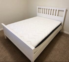 White wooden bed frame with mattress