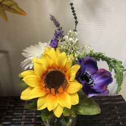 Artificial flower in glass bottle 