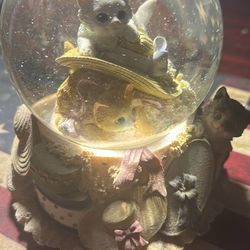 It’s a vintage cat snow globe (likely 1990s-2000s whimsical/fantasy style with winged fairy cats).