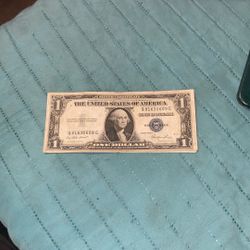 1935 Series $1 Silver Certificate, identifiable by its blue treasury seal and the "Silver Certificate