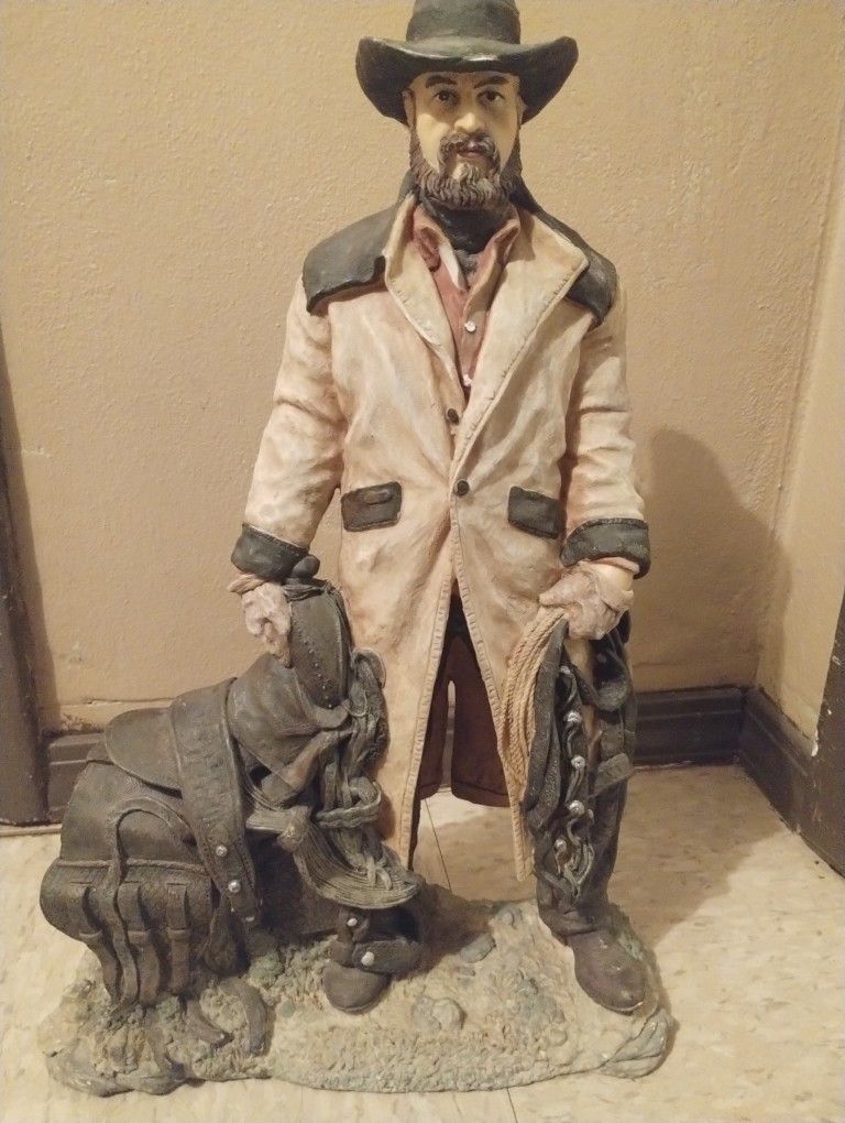 Statue Cowboy Standing With Saddle