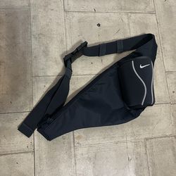 Gray Nike running waist pack featuring built in water bottle holder and zipper compartment
