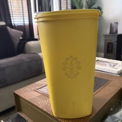 vintage yellow Tupperware Servalier canister, likely dating from the 1970s.