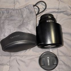 The lens in the image is a Canon EF 135mm f/2L USM telephoto lens. The new price for this lens typically ranges from approximately $1,000 to over $1,4