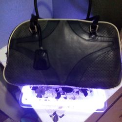 Prada, bowling bag; styled in black leather with white contrast...