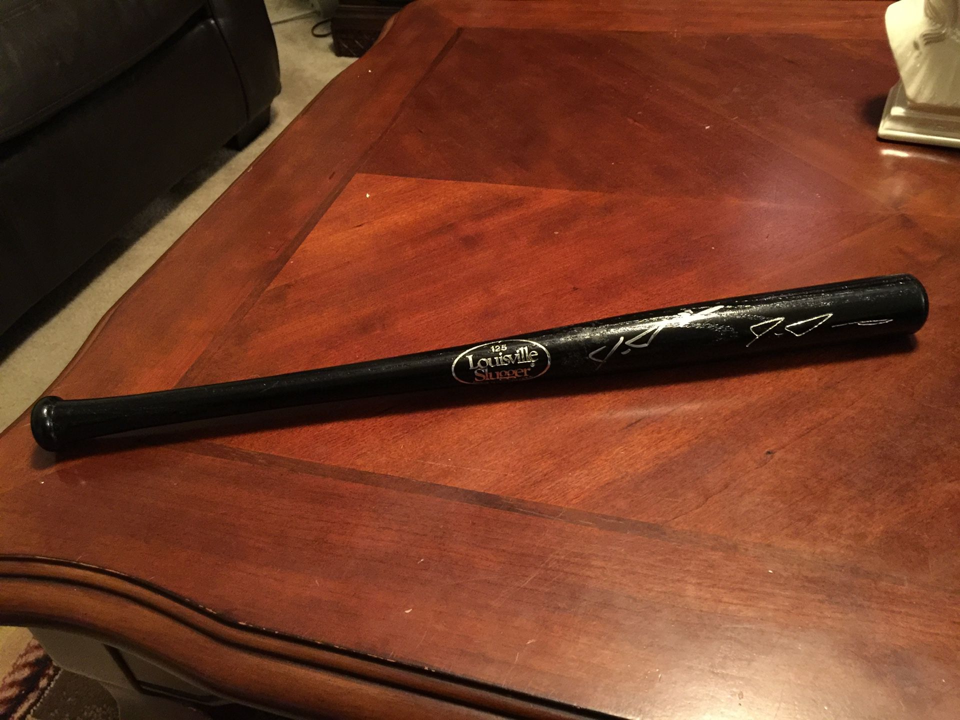 Black Louisville Slugger Mini Baseball Bat Autographed Excellent shape. Like new. Black glossy finish. Unsure who autographed it